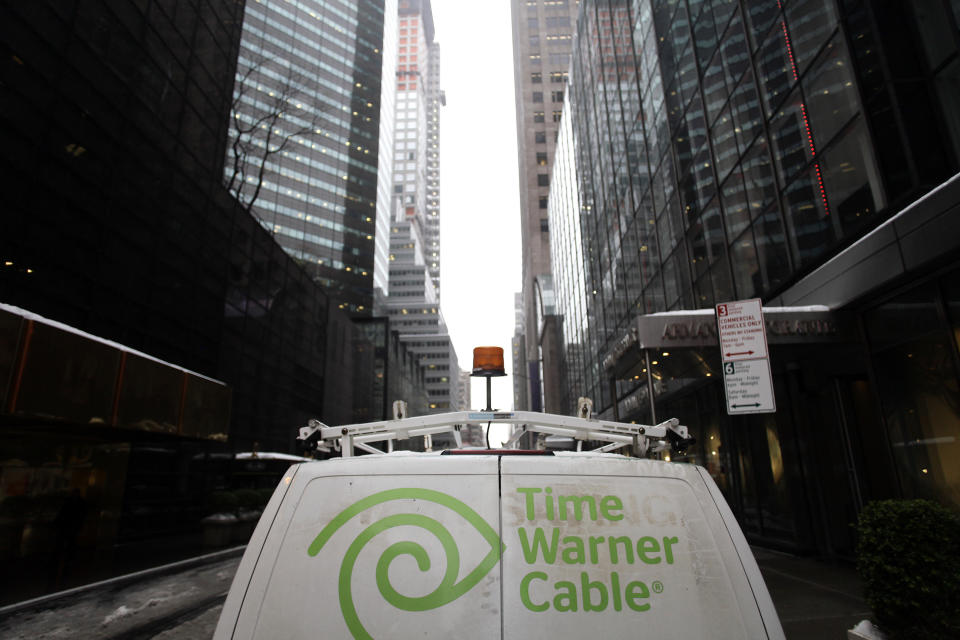 The Time Warner Cable logo is displayed on the back of a van in New York February 13, 2014. Comcast Corp's proposed $45.2 billion takeover of Time Warner Cable Inc could face close scrutiny from U.S. antitrust regulators because of the deal's potential to reshape the country's pay TV and broadband markets. REUTERS/Joshua Lott (UNITED STATES - Tags: BUSINESS SCIENCE TECHNOLOGY)