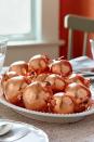 <p>Cover artificial pomegranates with copper leaf for festive decor that will never spoil.</p><p><strong>Step 1: </strong>Insert wooden skewers into artificial pomegranates<em>.</em> Coat each with adhesive size. Stand skewers upright in a piece of Styrofoam; let pomegranates dry until tacky (about 7 minutes).</p><p><strong><strong>Step 2: </strong> </strong>Following manufacturer's instructions, apply sheets of <a href="https://www.amazon.com/Speedball-Mona-Genuine-Copper-Sheet/dp/B001U3X39G/?tag=syn-yahoo-20&ascsubtag=%5Bartid%7C10050.g.2063%5Bsrc%7Cyahoo-us" rel="nofollow noopener" target="_blank" data-ylk="slk:copper leaf" class="link ">copper leaf</a> until pomegranate is covered (approximately 2 sheets). Repeat with each pomegranate. Display on a tray, in a bowl, or on a cake stand.</p><p><strong><a class="link " href="https://www.amazon.com/Gresorth-Pomegranate-Decoration-Artificial-Simulation/dp/B07XTFVMGJ/ref=sr_1_2_sspa?tag=syn-yahoo-20&ascsubtag=%5Bartid%7C10050.g.2063%5Bsrc%7Cyahoo-us" rel="nofollow noopener" target="_blank" data-ylk="slk:SHOP FAUX POMEGRANATES">SHOP FAUX POMEGRANATES</a></strong> </p>