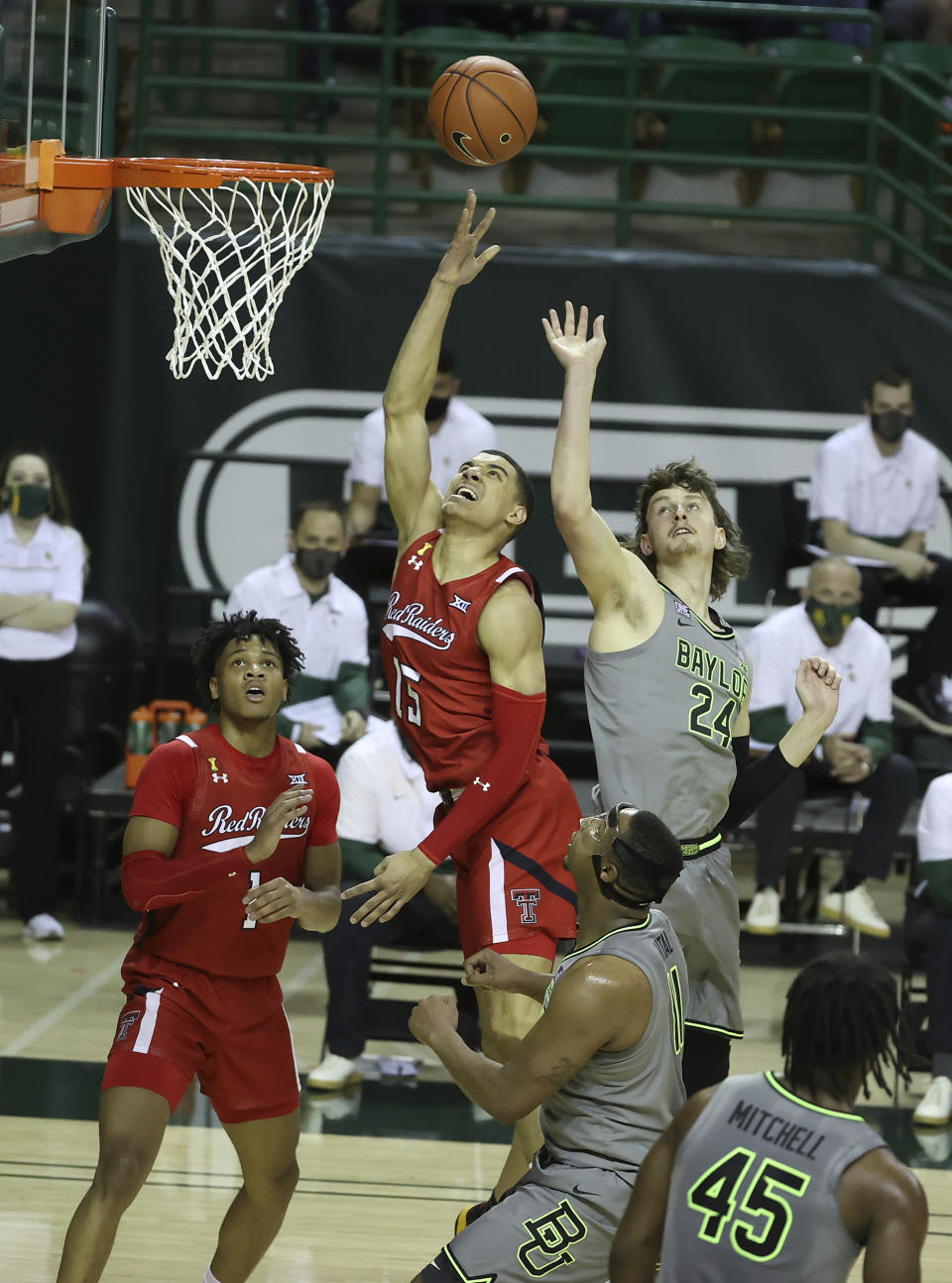 Texas Tech guard Kevin McCullar (15) attempts a shot past Baylor guard Matthew Mayer (24) in the first half of an NCAA college basketball game Sunday, March 7, 2021, in Waco, Texas. (AP Photo/Jerry Larson)