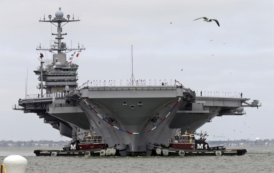 The nuclear aircraft carrier Harry S. Truman approaches the pier at Naval Station Norfolk in Norfolk, Va., Friday, April 18, 2014. The Carrier Strike Group is returning form a 9-month deployment to the Middle East. (AP Photo/Steve Helber)