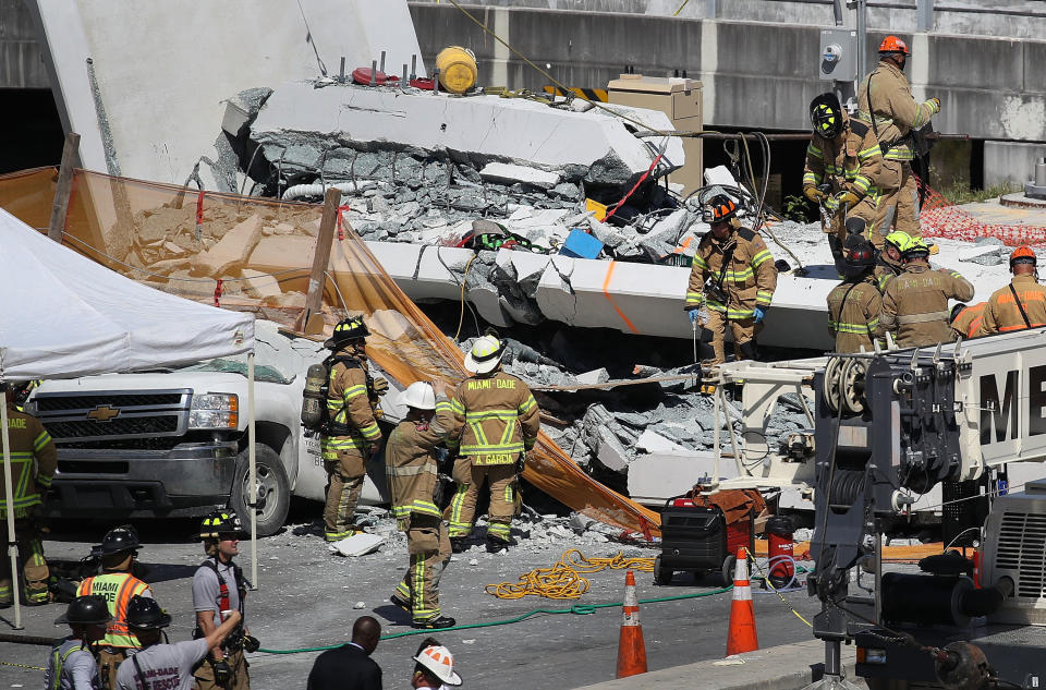 Miami-Dade Fire Rescue personnel and other rescue units work at the scene of the collapse.