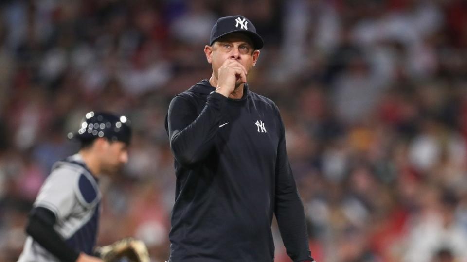 New York Yankees manager Aaron Boone (17) reacts during the fourth inning against the Boston Red Sox at Fenway Park.