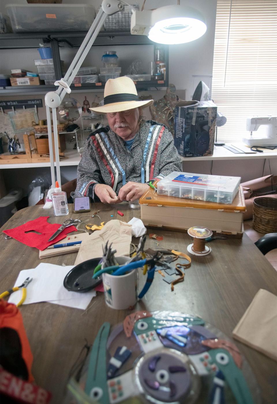 Darrel Roberts, also known as Wind Dancer, creates a piece of tribal jewelry in the crafts room at the Native Paths Cultural Heritage Resource Center and Museum on Wednesday, Jan. 26, 2023.