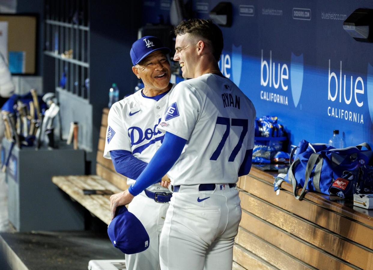 Dave Roberts shakes River Ryan's hand in the dugout.