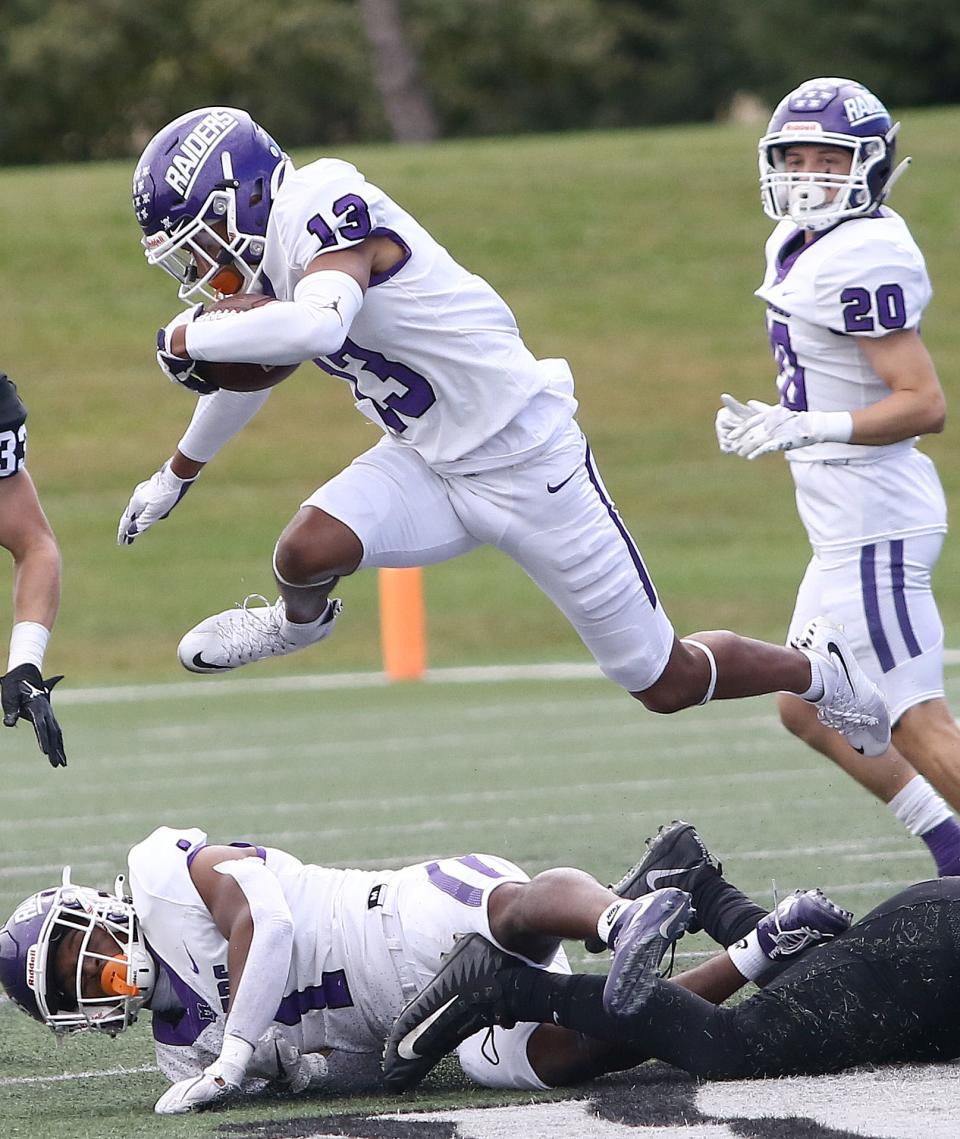 Mount Union's Jay Farra (13) leaps over defenders during a punt return during first-half action at Ohio Northern University Saturday, October 1, 2022.