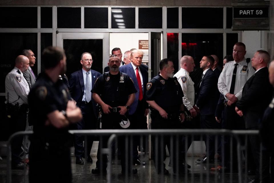 Former President Donald Trump is escorted to a courtroom Tuesday 4 April (Copyright 2023 The Associated Press. All rights reserved.)