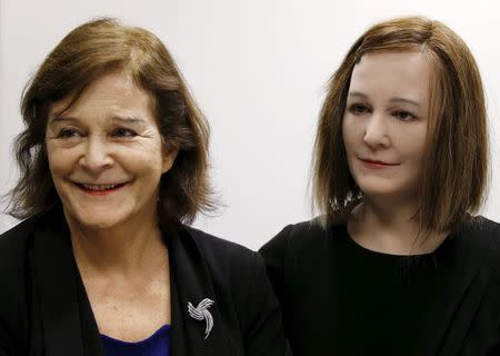 Nanyang Technological University's (NTU) Professor Nadia Thalmann (L) and Nadine, a humanoid that she and her team created, take questions during an interview with Reuters at their campus in Singapore March 1, 2016. REUTERS/Edgar Su