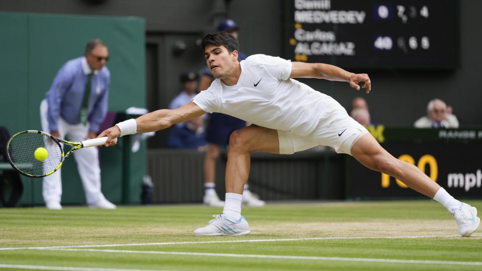 Carlos Alcaraz of Spain plays a forehand return to Daniil Medvedev of Russia during their semifinal match at the Wimbledon tennis championships in London, Friday, July 12, 2024. (AP Photo/Kirsty Wigglesworth)