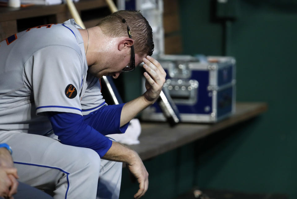 New York Mets relief pitcher Jacob Rhame sits on the bench after he was removed during the third inning of the team's baseball game against the Washington Nationals at Nationals Park, Tuesday, July 31, 2018, in Washington. The Nationals won 25-4. (AP Photo/Alex Brandon)