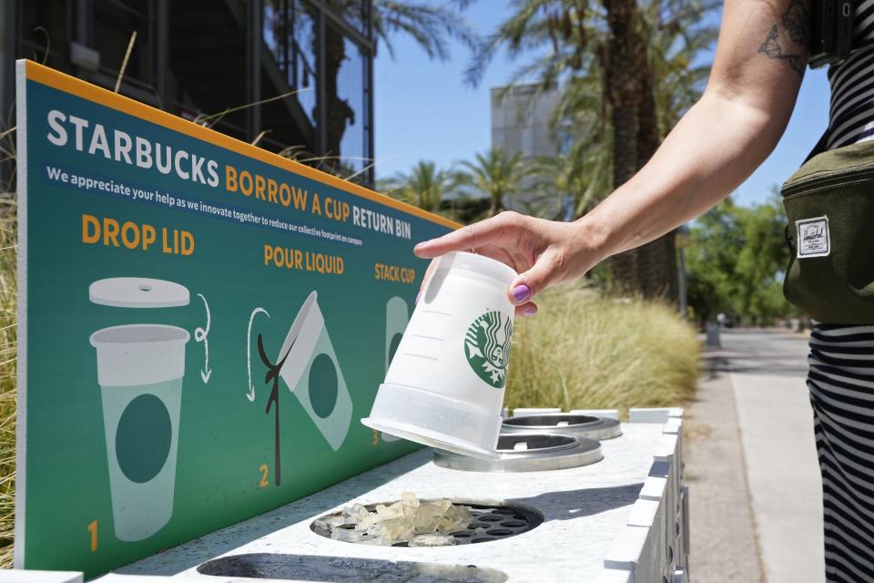 A reusable cup is returned to a borrow a cup return bin at an Arizona State University Starbucks shop Wednesday, June 7, 2023, in Tempe, Ariz. At the Arizona State store, if customers don't bring their own cup, they are given a reusable plastic one with a Starbucks logo. If they bring it back, they get $1 off, just like customers who bring their own. (AP Photo/Ross D. Franklin)