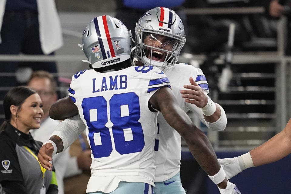 Dallas Cowboys quarterback Dak Prescott, right, celebrates his touchdown run with teammate CeeDee Lamb (88) in the first half of an NFL football game against the New York Giants, Sunday, Nov. 12, 2023, in Arlington, Texas. (AP Photo/Tony Gutierrez)