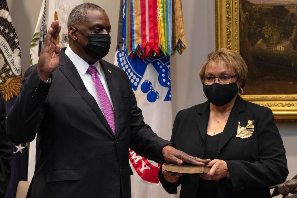 Lloyd Austin, a retired U.S. Army four-star general, is sworn in as Secretary of Defense as his wife, Charlene Austin, holds the Bible in Washington D.C. on Jan. 25, 2021.<span class="copyright">Jim Watson—AFP/Getty Images</span>