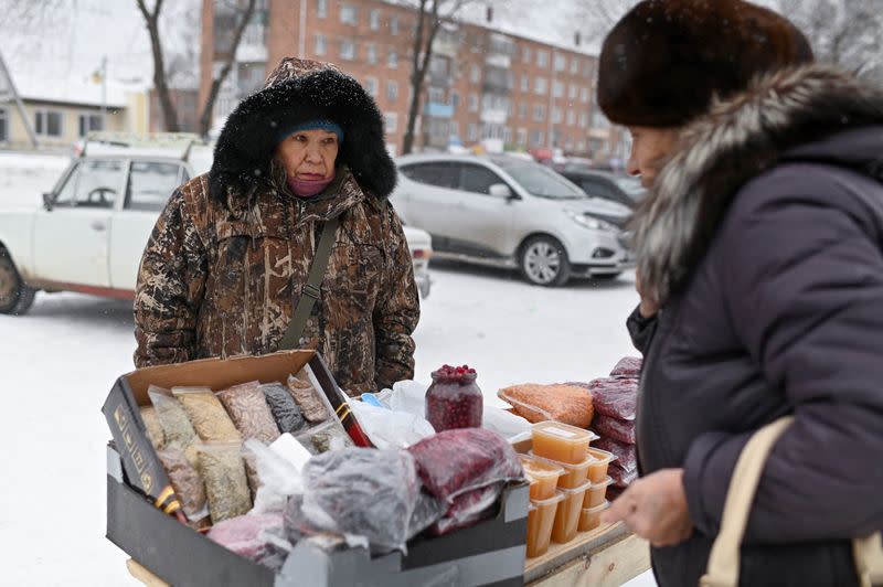 Pensioner Gulsina Zhemaletdinova works at a street market in the Siberian town of Tara