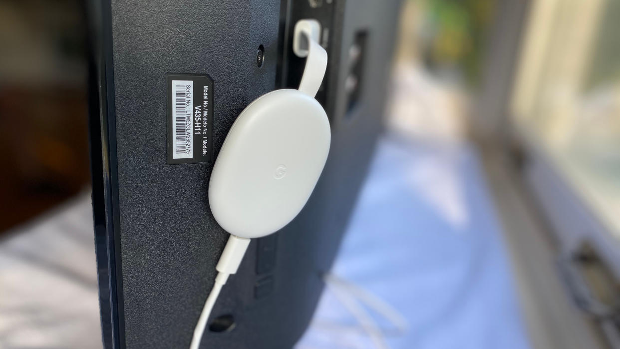  Chromecast with Google TV plugged into a TV's HDMI port. 