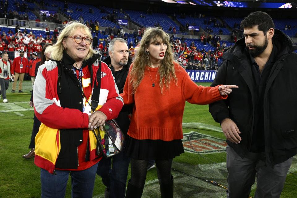 Taylor Swift, center, and Donna Kelce walk on the field after the Kansas City Chiefs won the AFC Championship NFL football game against the Baltimore Ravens, Sunday, Jan. 28, 2024, in Baltimore. (AP Photo/Nick Wass)
