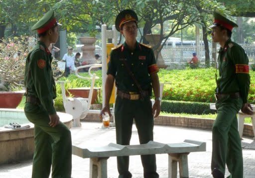 Vietnamese soldiers at a public park near the Ho Chi Minh City People's Court. A court in southern Vietnam has jailed three bloggers for "anti-state propaganda", including one whose case has been raised by US President Barack Obama, at a brief but dramatic hearing