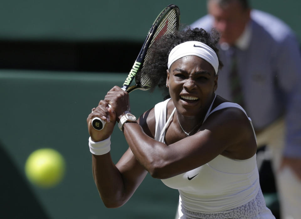 Serena Williams of the United States returns a shot to Garbine Muguruza of Spain during the women's singles final at the All England Lawn Tennis Championships in Wimbledon, London, Saturday July 11, 2015. (AP Photo/Pavel Golovkin)
