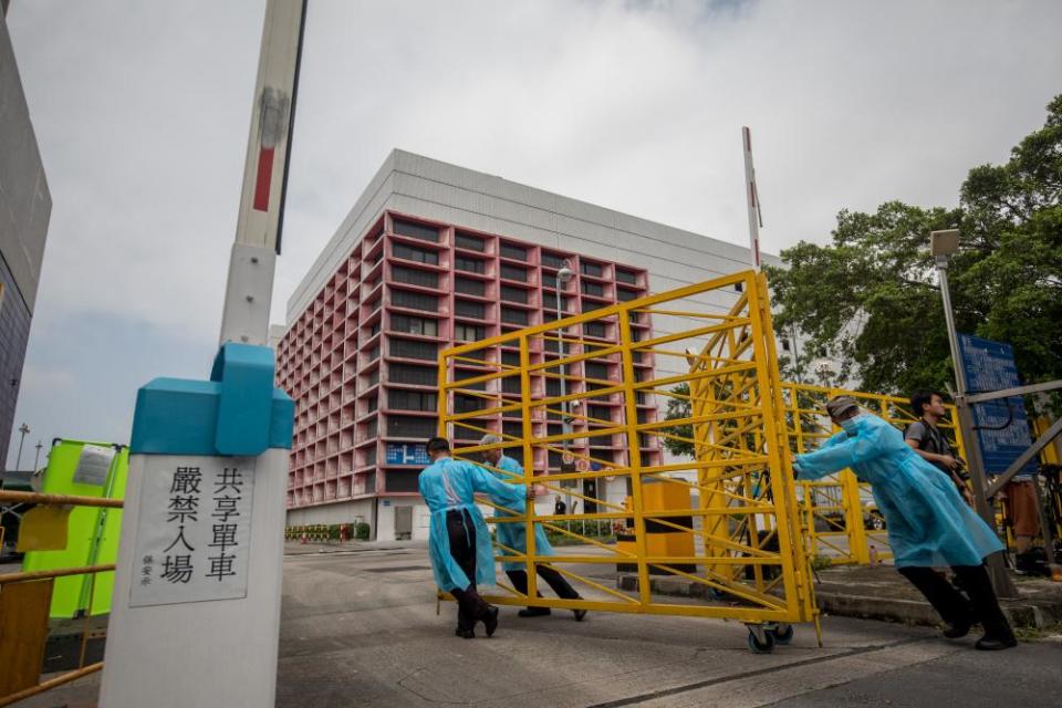 Workers close a gate outside Sheung Shui Slaughterhouse in Hong Kong.