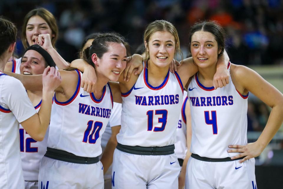 Hammon players celebrate after a 59-49 win against Lomega in the Class B girls basketball state title game on Saturday at State Fair Arena.