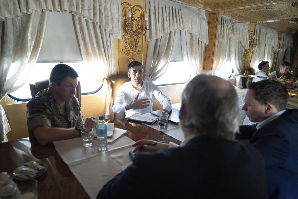 Britain's Prime Minister Rishi Sunak, top right, sits next to Vice Chief of the Defence Staff Major General Gwyn Jenkins, left, on a train travelling through Ukraine as he heads to meet with President Volodymyr Zelensky after announcing a major new package of £2.5 billion in military aid to the country over the coming year, near Kyiv, Ukraine, Friday Jan. 12, 2024. (Stefan Rousseau/Pool via AP)