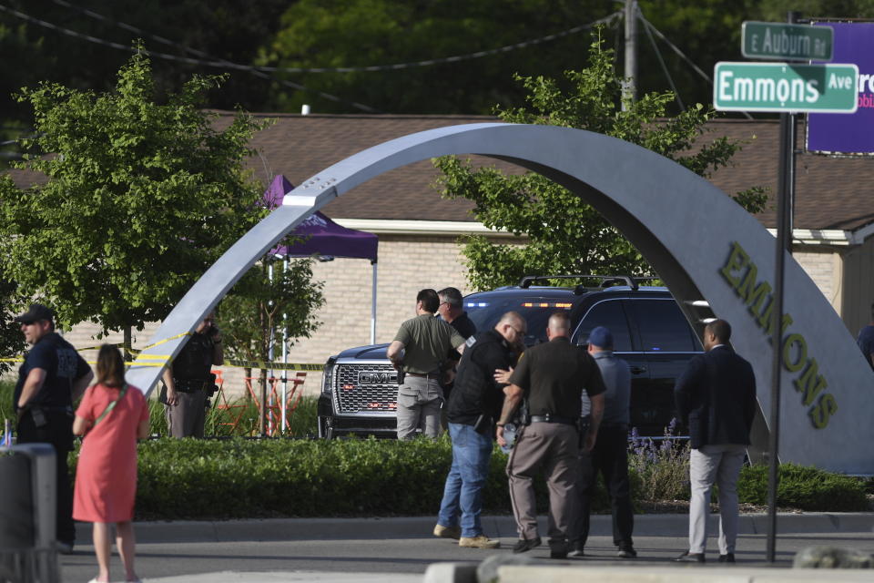 Officials with the Oakland County Sheriff's Department, Rochester Hills Fire Department and other jurisdictions secure the scene of a shooting at the Brooklands Plaza Splash Pad, Saturday, June 15, 2024, in Rochester Hills, Mich. (Daniel Mears/Detroit News via AP)