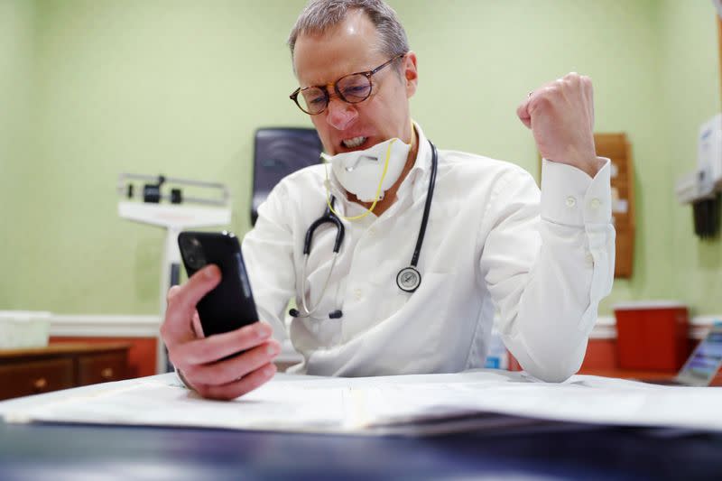 Dr Greg Gulbransen takes part in a telemedicine call with a patient while maintaining visits with both his regular patients and those confirmed to have the coronavirus disease (COVID-19) at his pediatric practice in Oyster Bay, New York