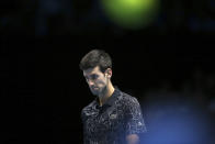 Novak Djokovic of Serbia walks across the court during his ATP World Tour Finals tennis match against John Isner of the United States at the O2 Arena in London, Monday Nov. 12, 2018. (AP Photo/Tim Ireland)