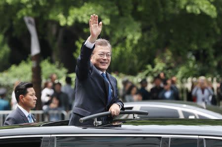 South Korean President Moon Jae-in waves as he leaves the National Cemetery after inaugural ceremony in Seoul, South Korea, May 10, 2017. Yonhap via REUTERS