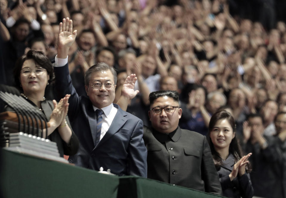 South Korean President Moon Jae-in, second from left, his wife Kim Jung-sook, left, North Korean leader Kim Jong Un, second from right, and his wife Ri Sol Ju, greet upon their arrival before the mass games performance of "The Glorious Country" at May Day Stadium in Pyongyang, North Korea, Wednesday, Sept. 19, 2018. (Pyongyang Press Corps Pool via AP)