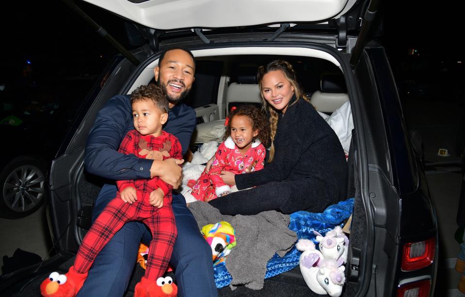 John Legend and Chrissy Teigen are pictured with Miles and Luna at Netflix's "Jingle Jangle: A Christmas Journey" drive-in premiere on Nov. 13 in Los Angeles. (Photo: Matt Winkelmeyer via Getty Images)