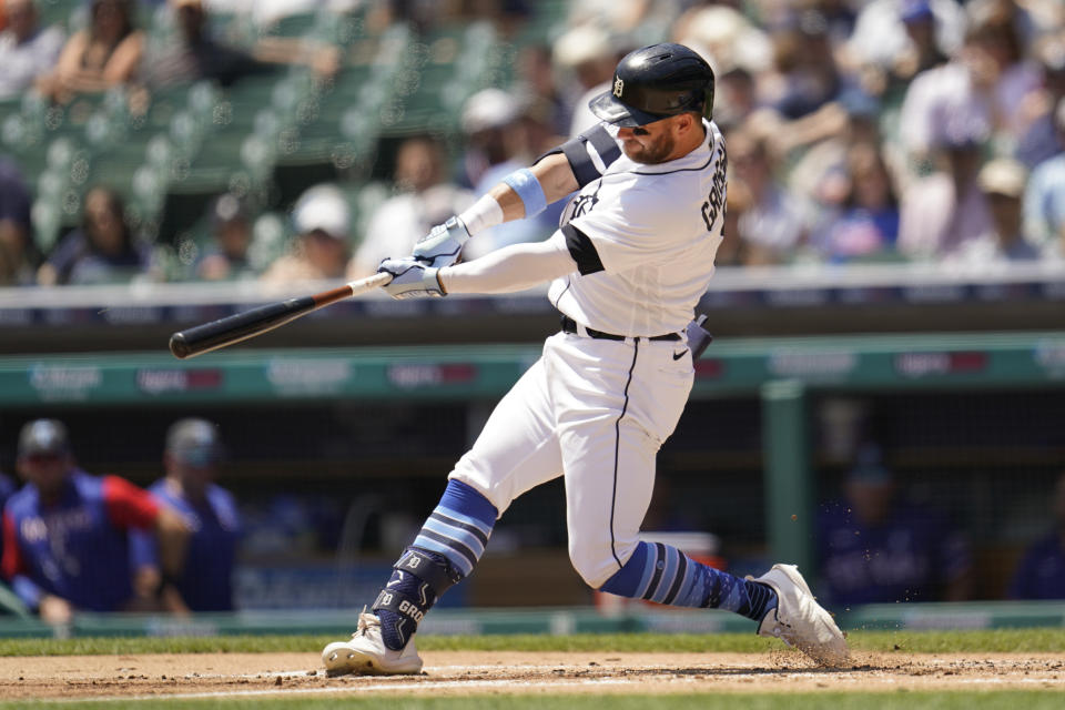 Detroit Tigers left fielder Robbie Grossman hits a three-run home run against the Texas Rangers in the first inning of a baseball game in Detroit, Sunday, June 19, 2022. (AP Photo/Paul Sancya)