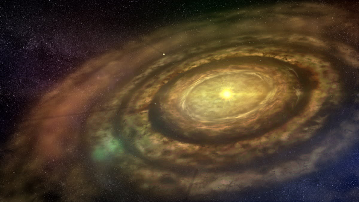  Artist's conception of a protoplanetary disc, showing yellowish-gray rings of dust around a central yellow star. 