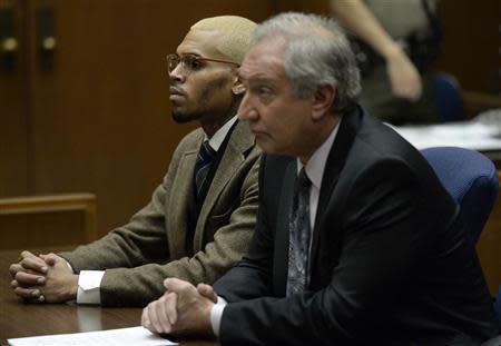 Singer Chris Brown (L) and his attorney Mark Geragos appear in court during a probation violation hearing in which his probation was revoked at Los Angeles Superior Court in Los Angeles, December 16, 2013. REUTERS/Kevork Djansezian/Pool