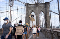 Protesters and activists walk across the Brooklyn Bridge, Saturday, June 6, 2020, in New York. Protests continued Saturday following the death of George Floyd who died after being restrained by Minneapolis police officers on May 25. (AP Photo/Craig Ruttle)