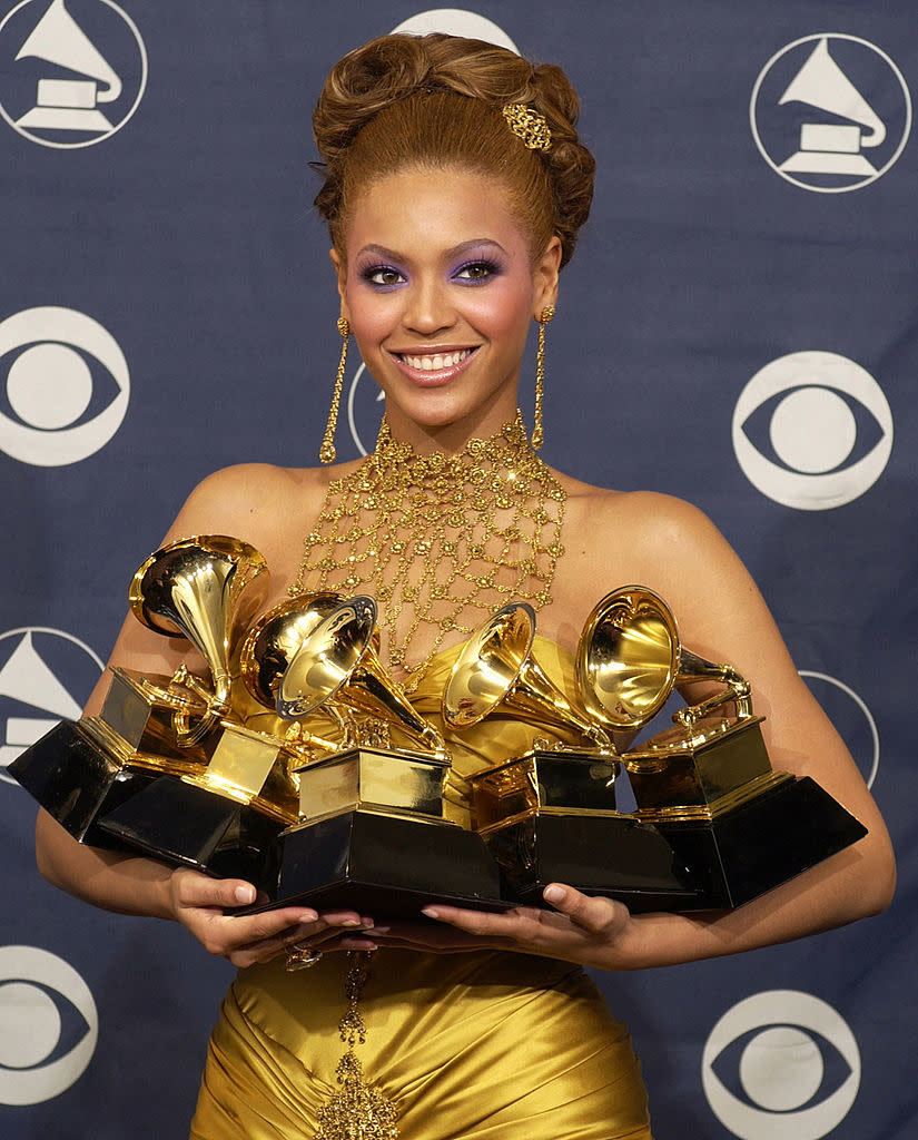 closeup of her holding her awards