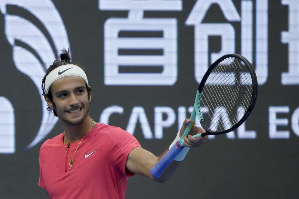 Lorenzo Musetti of Italy reacts during the second round of the men's singles against Carlos Alcaraz of Spain in the China Open tennis tournament at the Diamond Court in Beijing, Sunday, Oct. 1, 2023. (AP Photo/Andy Wong)