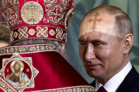 FILE - Russian Orthodox Patriarch Kirill, left, talks to President Vladimir Putin, right, during the Easter service in the Christ the Savior Cathedral in Moscow, Russia, on April 28, 2019. Putin, who turned 70 on Friday, has found himself increasingly cornered with his army suffering humiliating defeats in Ukraine, hundreds of thousands of Russians fleeing his mobilization order and rifts opening up among his top lieutenants. (AP Photo/Alexander Zemlianichenko, File)