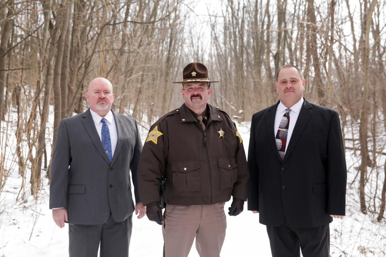 Carroll County Sheriff Tobe Leazenby, center, and detectives, Tony Liggett, left, and Kevin Hammond, right, pose for a photo on the Monon High Bridge Trail, Friday, Feb. 7, 2020 in Delphi.