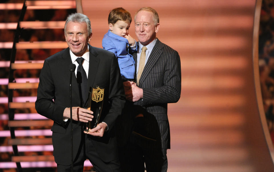 Former NFL player Joe Montana speaks as he presents the award for AP Most Valuable Player, as Archie Manning holds his grandson Marshall Manning at the third annual NFL Honors at Radio City Music Hall on Saturday, Feb. 1, 2014, in New York. Archie Manning accepted on behalf of his son Peyton. (Photo by Evan Agostini/Invision for NFL/AP Images)
