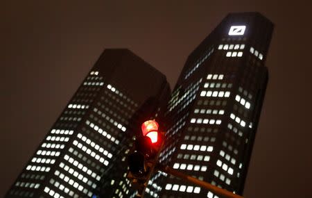 A red traffic light is photographed in front of the head quarters of Germany's largest business bank, Deutsche Bank, in Frankfurt, Germany, December 6, 2017. REUTERS/Kai Pfaffenbach