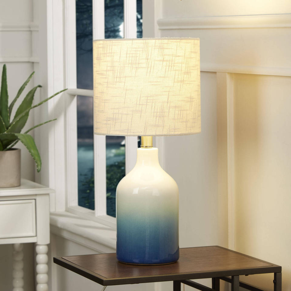 For a pop of color, you could go with this blue ombre lamp, which is supposed to blend well with <a href="https://www.huffpost.com/entry/bohemian-furniture-and-home-decor_n_59e7a9e0e4b00905bdae6e54" target="_blank" rel="noopener noreferrer">bohemian decor</a> (especially anything rattan). It features a ceramic base and white lamp shade. You'll have to get a 60-watt or 3-watt CGL bulb. <a href="https://fave.co/3bZEoym" target="_blank" rel="noopener noreferrer">﻿Find it for $30 at Walmart</a>.