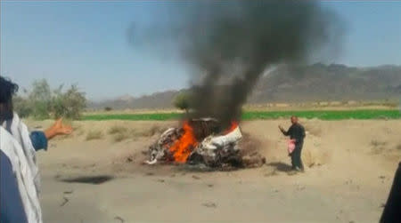 A car is seen on fire at the site of a drone strike believed to have killed Afghan Taliban leader Mullah Akhtar in southwest Pakistan in this still image taken from video, May 21, 2016. REUTERS/via REUTERS TV