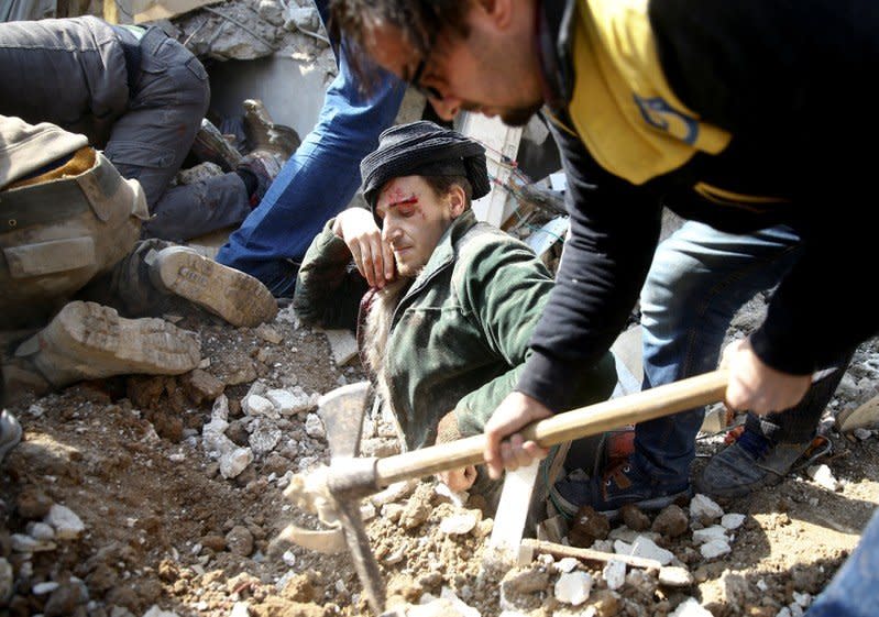 A man gets stuck under debris at a damaged site after an airstrike in the Saqba area, in the eastern Damascus suburb of Ghouta, Syria January 9, 2018. REUTERS/Bassam Khabieh/File photo