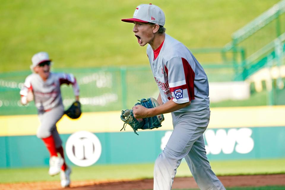 Sioux Falls, S.D.'s Gavin Weir, right, yells as he walks off the field after striking out the last Lafayette, La., batter in the fifth inning of a baseball game at the Little League World Series in South Williamsport, Pa., Friday, Aug. 20, 2021. (AP Photo/Tom E. Puskar)
