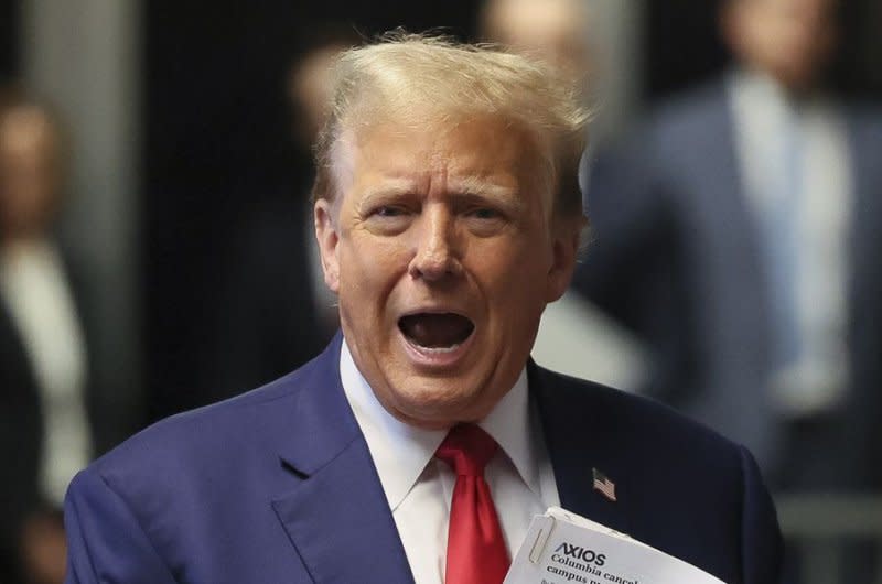 Former President Donald Trump speaks to reporters as he arrives for his trial at Manhattan criminal court in New York on Monday. Pool Photo by Brendan McDermid/UPI