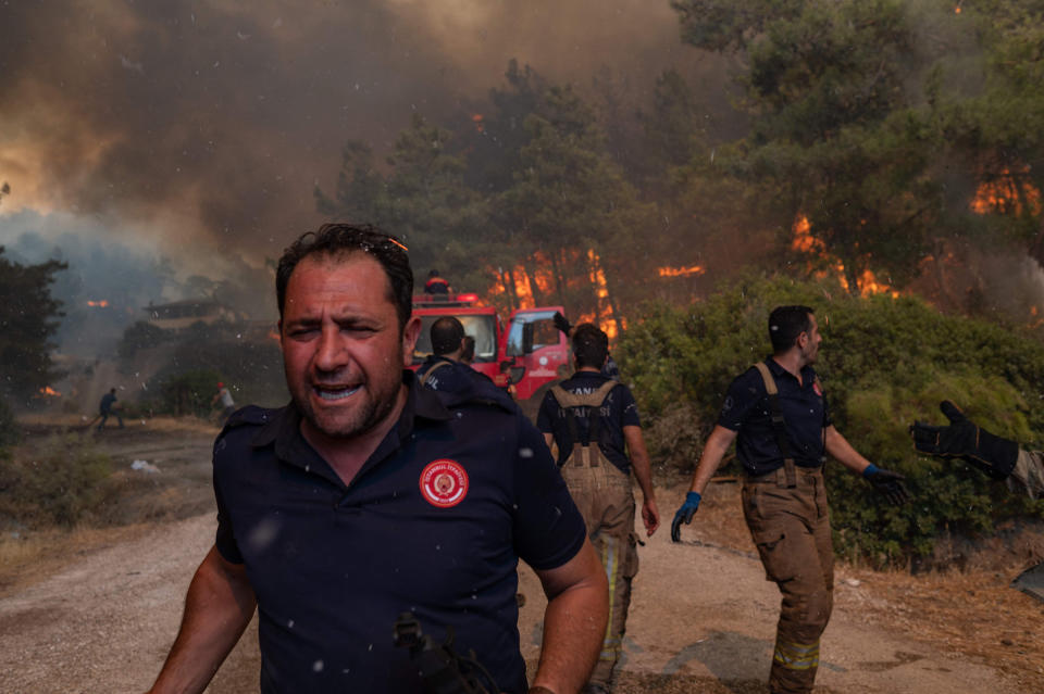 Firefighters battle a wildfire in Mugla, Marmaris district, Turkey, on Aug. 2. Turkey's struggles against its deadliest wildfires in decades come as a blistering heatwave grips southeastern Europe.<span class="copyright">Yasin Akgul—AFP/Getty Images</span>