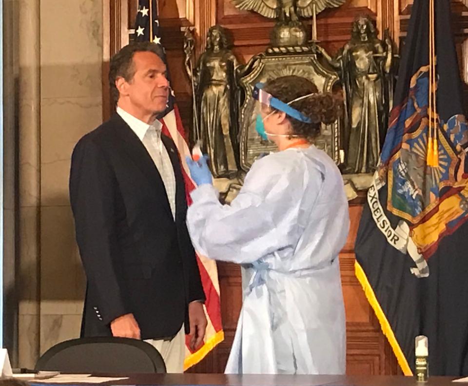 New York Gov. Andrew Cuomo gets ready for a COVID-19 test during his daily coronavirus briefing at the state Capitol in Albany; May 17, 2020.