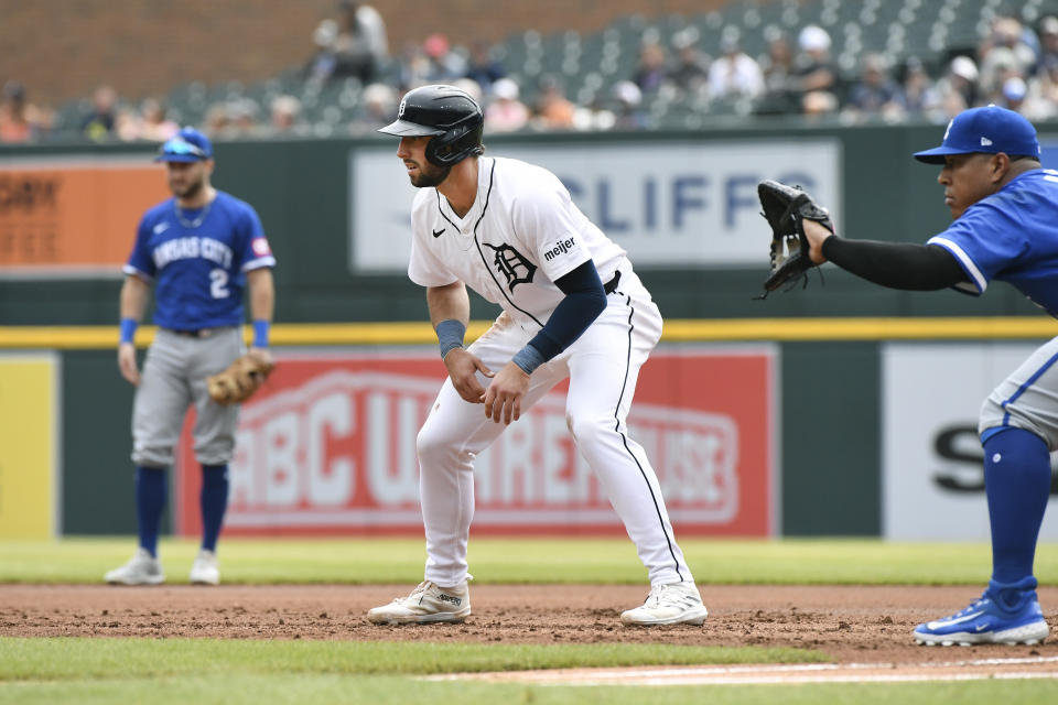 Detroit Tigers' Matt Vierling, center, looks on as Kansas City Royals first baseman Salvador Perez, right, stands near him in the first inning of a baseball game, Sunday, April 28, 2024, in Detroit. In left background is second baseman Garrett Hampson. (AP Photo/Jose Juarez)