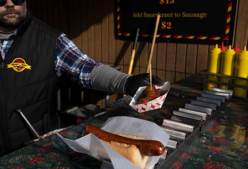 The Wurst Haus serves up curry wurst alongside traditional brats at the Christkindlmarkt Christmas market in Carmel on Wednesday, Nov. 22, 2023.