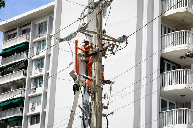 LUMA workers repair a power line in San Juan, Puerto Rico, on Sept. 20. (Photo: Jose Jimenez via Getty Images)